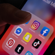 Stock photo of social media icons on phone screen